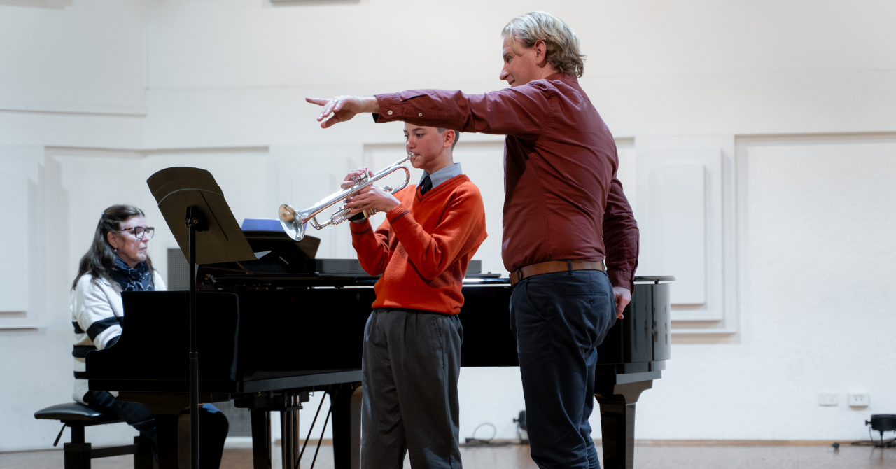 A young trumpeter receives expert guidance from Mark Bain, tutti trumpet of the Tasmanian Symphony Orchestra, during a hands-on workshop at the Orange Regional Conservatorium of Music. Photo credit: James Buchanan